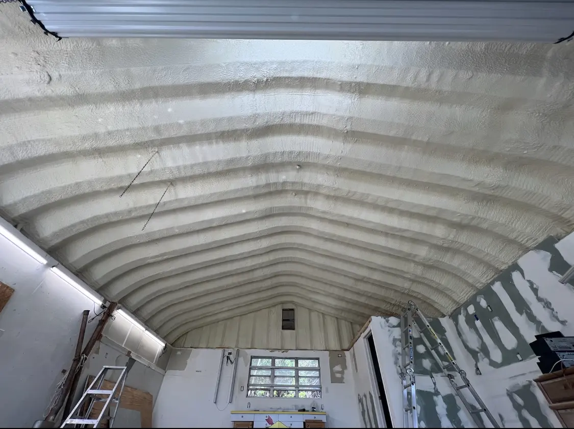 Spray polyurethane foam applied to the underside of a metal roof deck in Dickson